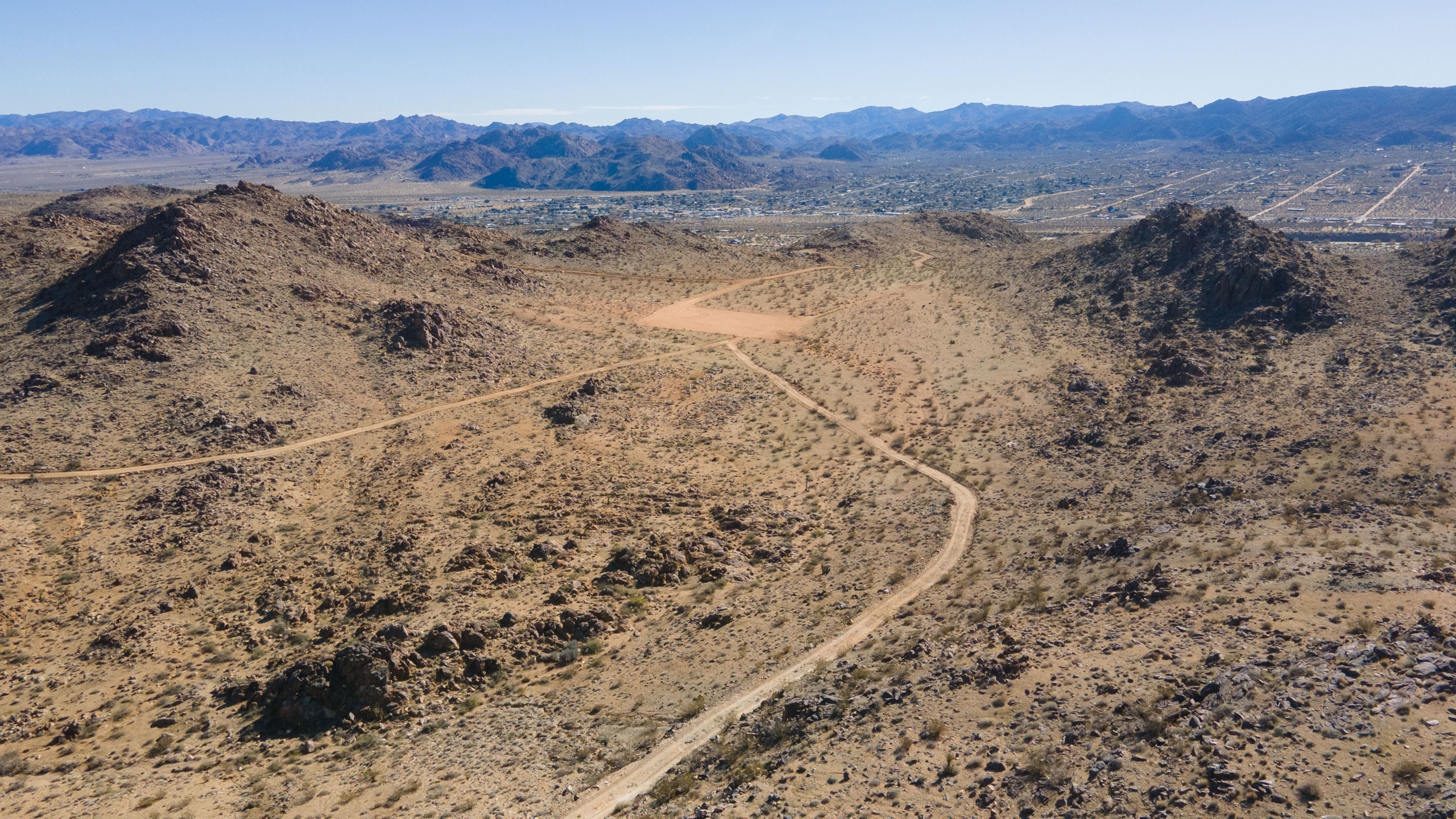 Aerial view of the graded homesite pad at the crown of the property, ready for construction